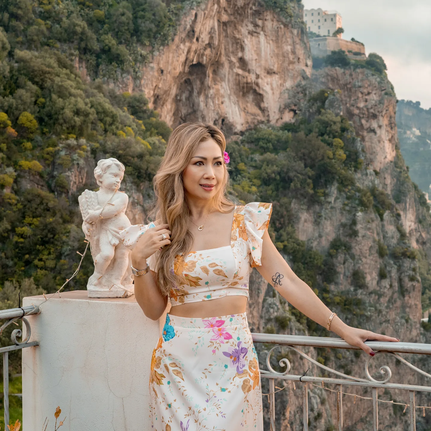 A portrait of Anh against the coastline and cliffs