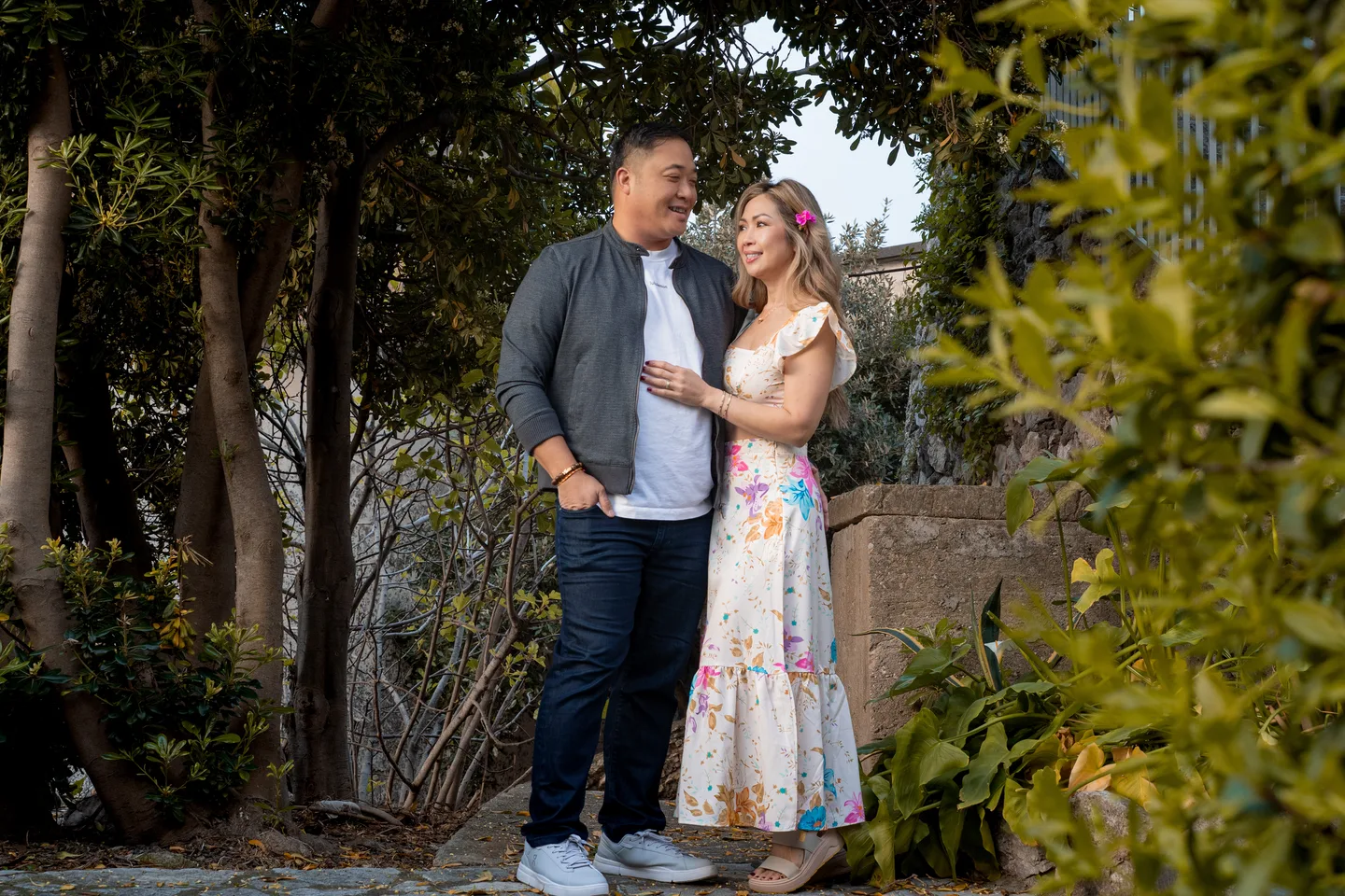 The couple together beneath the garden trees