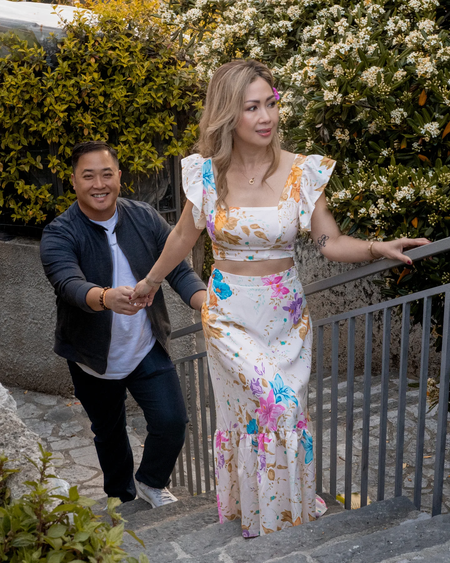 Anh smiling on the steps with her companion behind her