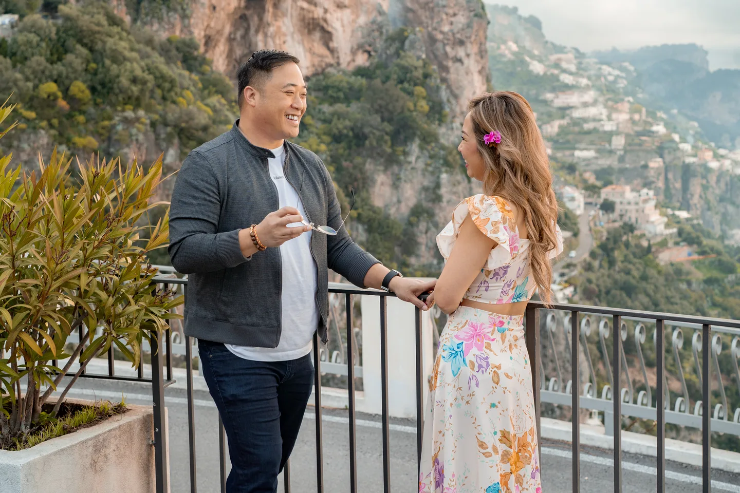 The couple at a village viewpoint above the coast