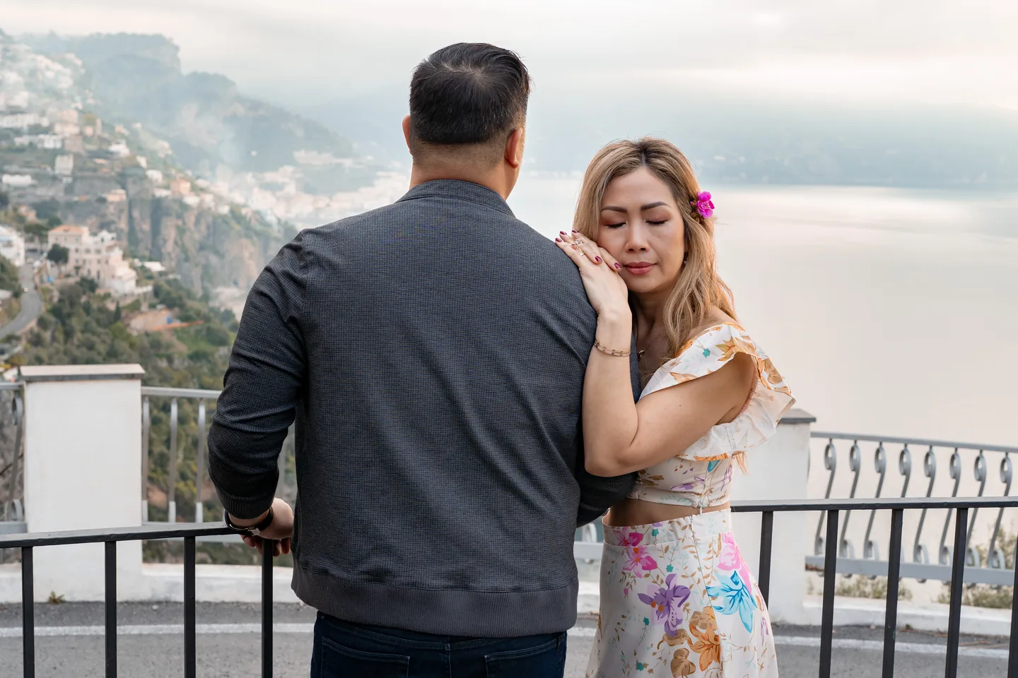 Anh leaning towards her companion above the sea
