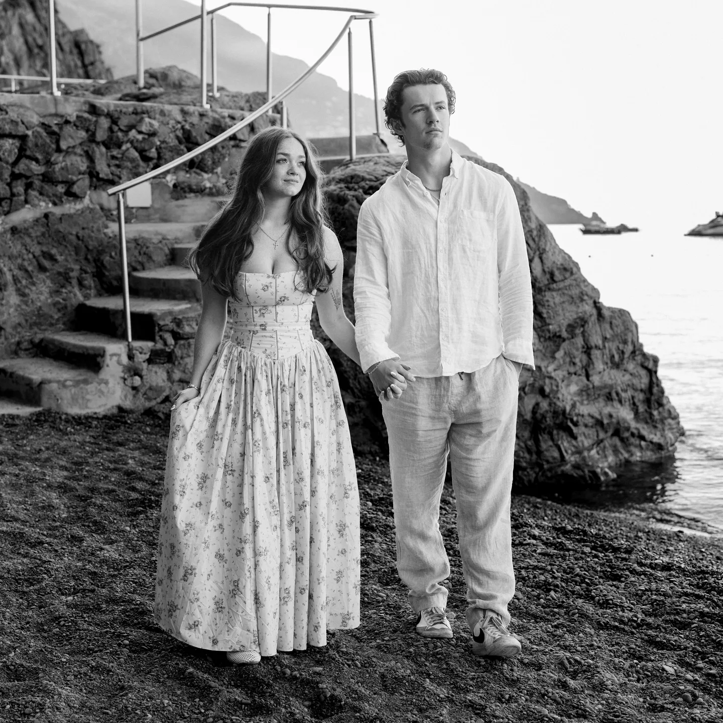 The couple at the beach steps in black and white