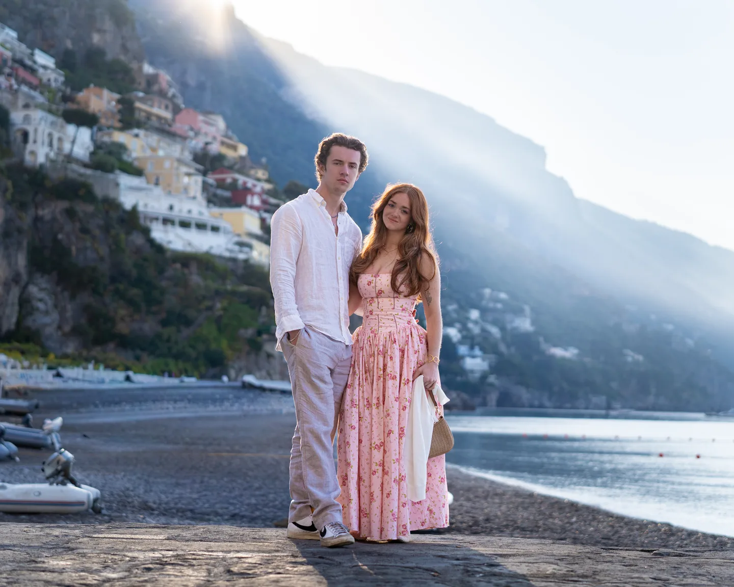 The couple on the beach with the mountains behind them