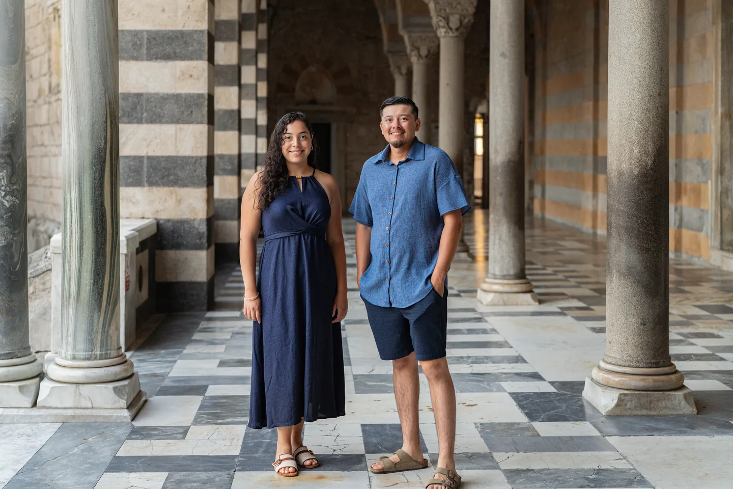 The couple among the striped columns of Amalfi Cathedral