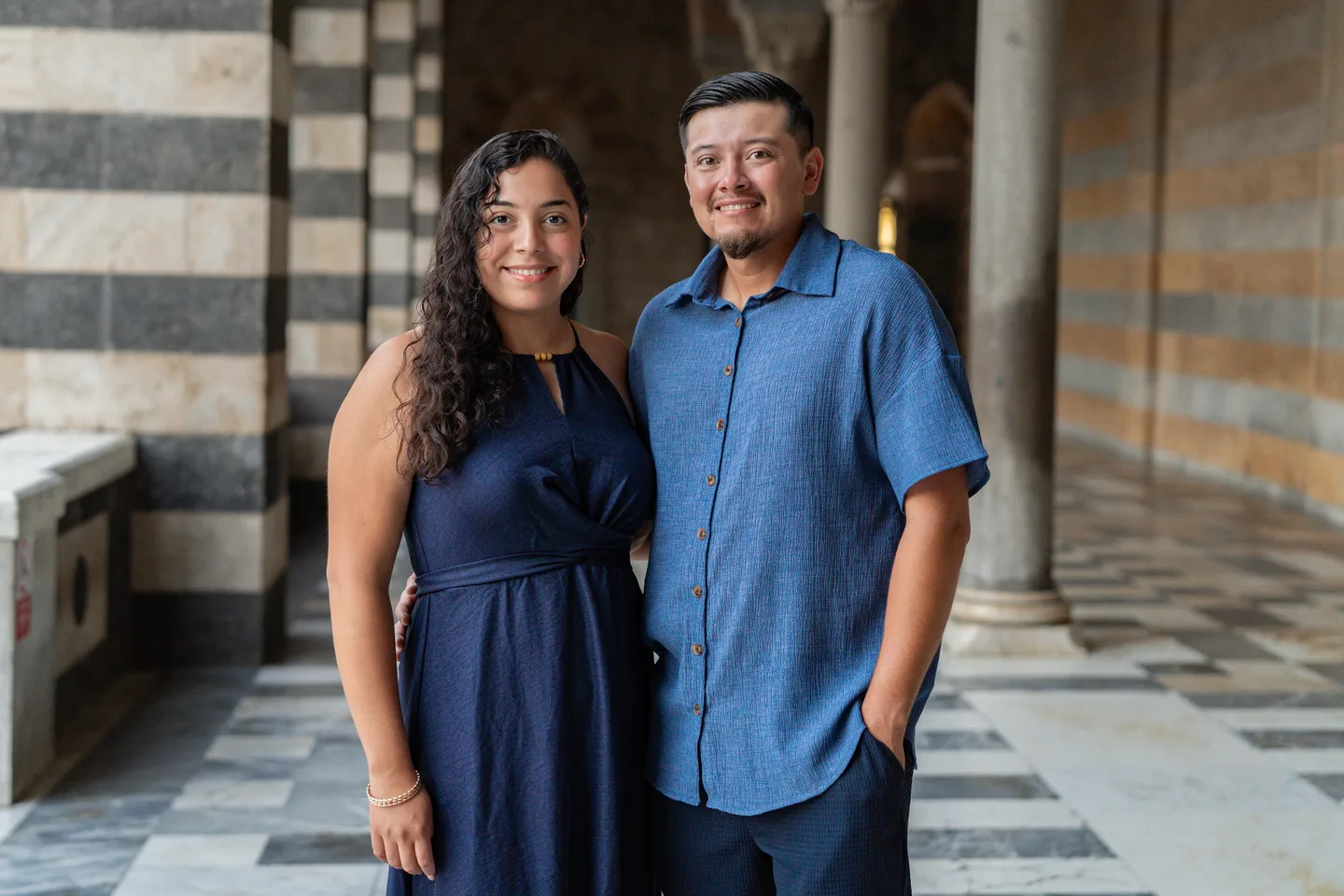 A close portrait of Esmeralda and her companion beneath the cathedral portico