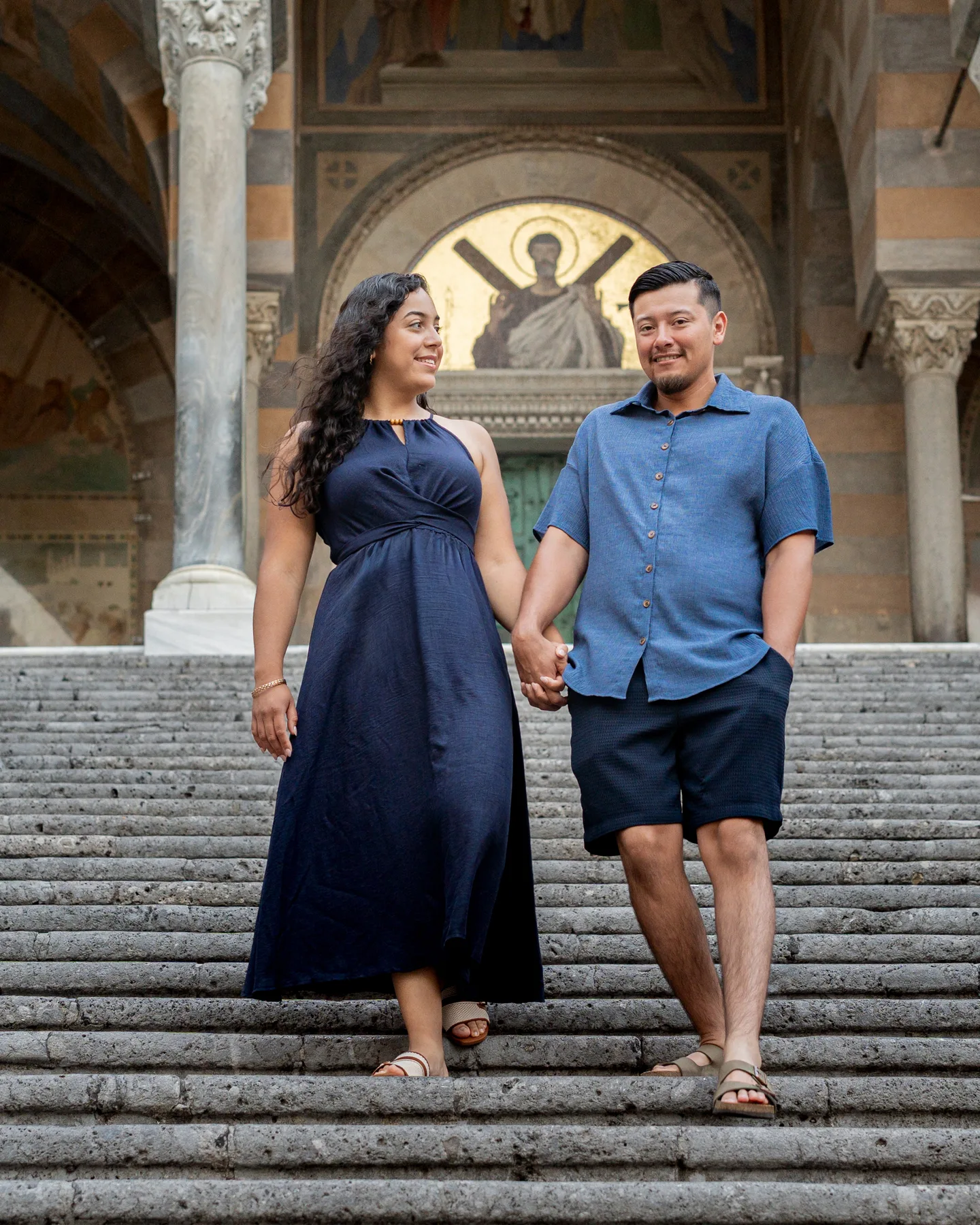 Esmeralda and her companion holding hands on the cathedral steps