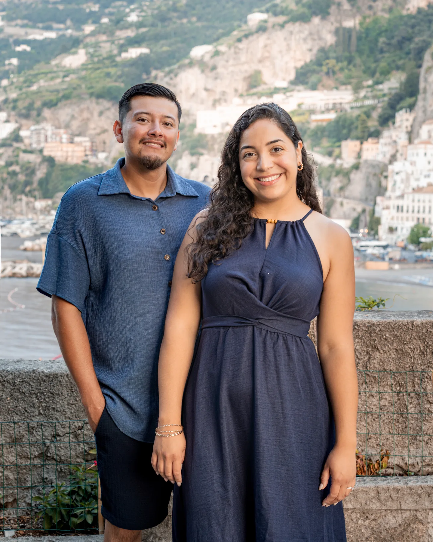 A portrait of the couple with Amalfi across the water