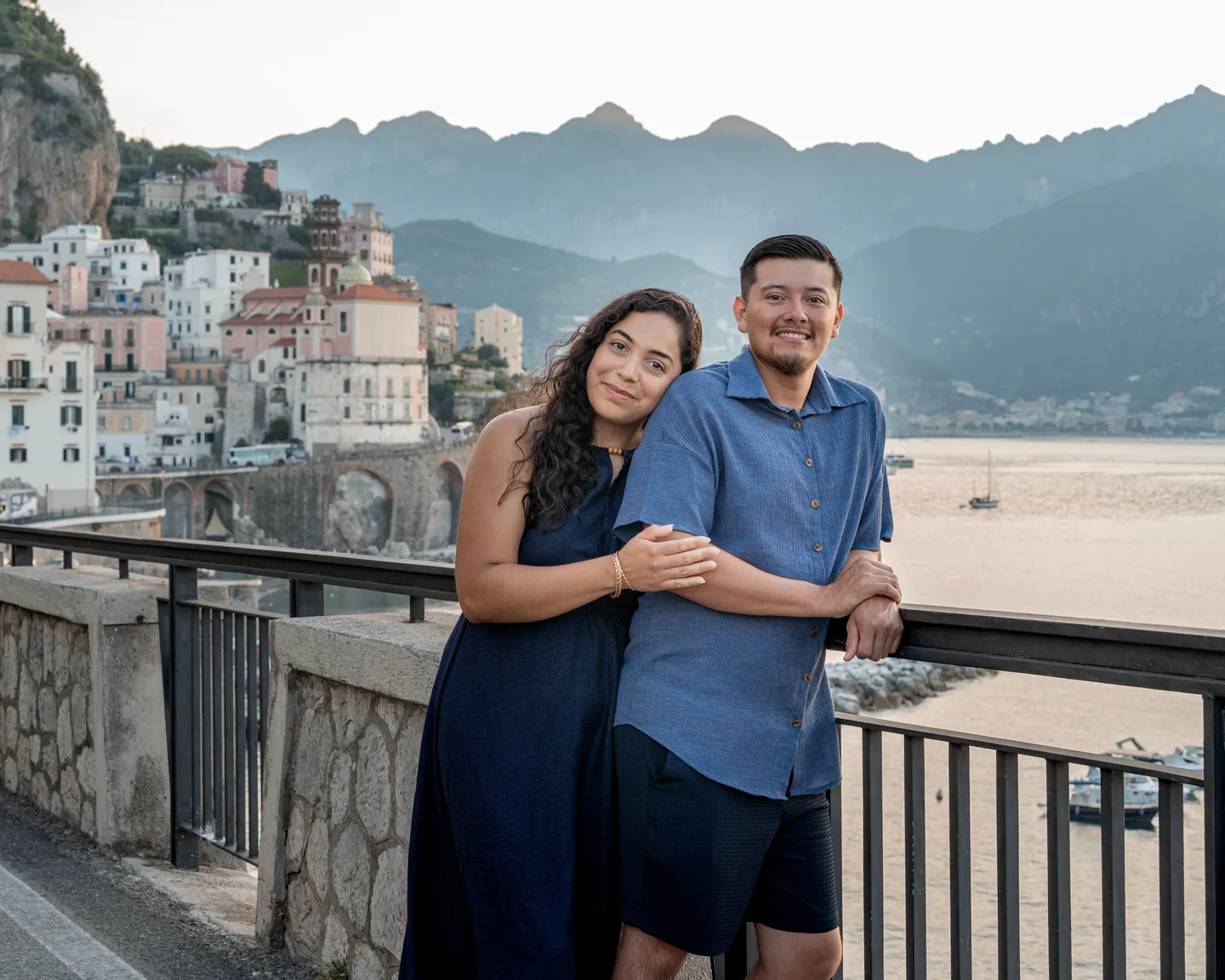 The couple laughing at the railing above Atrani