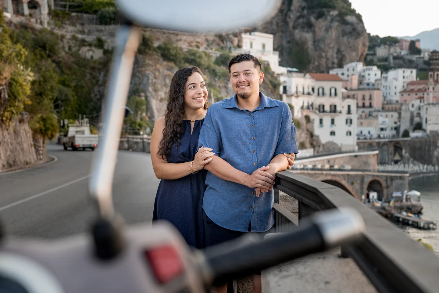 A playful reflection of the couple in a scooter mirror