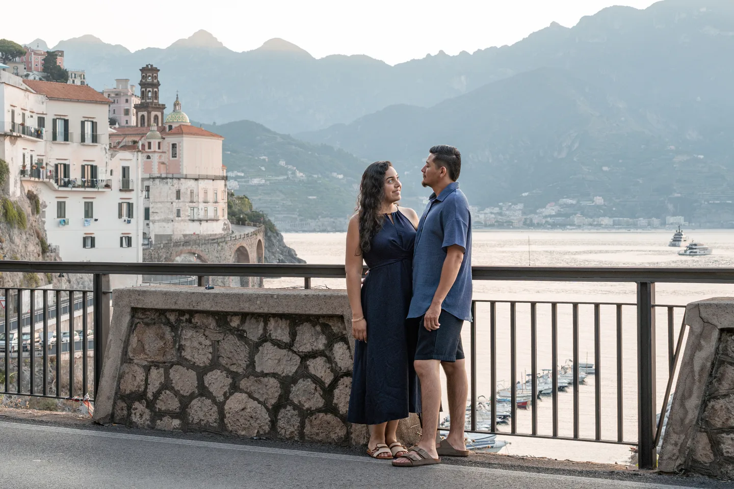 The couple facing one another above Atrani’s waterfront