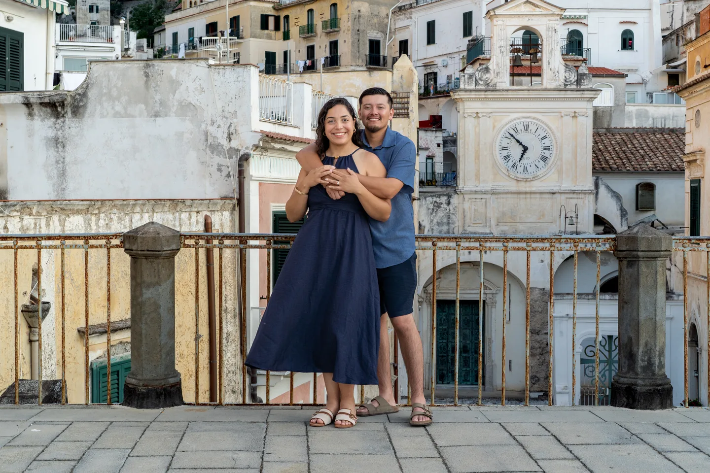 The couple standing together by the railing in Atrani