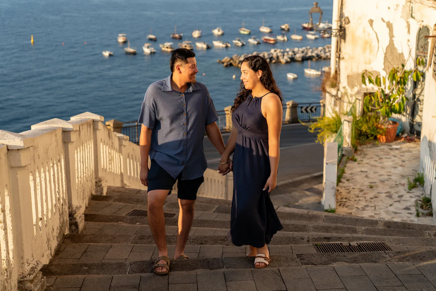 Esmeralda and her companion smiling on the seaside steps