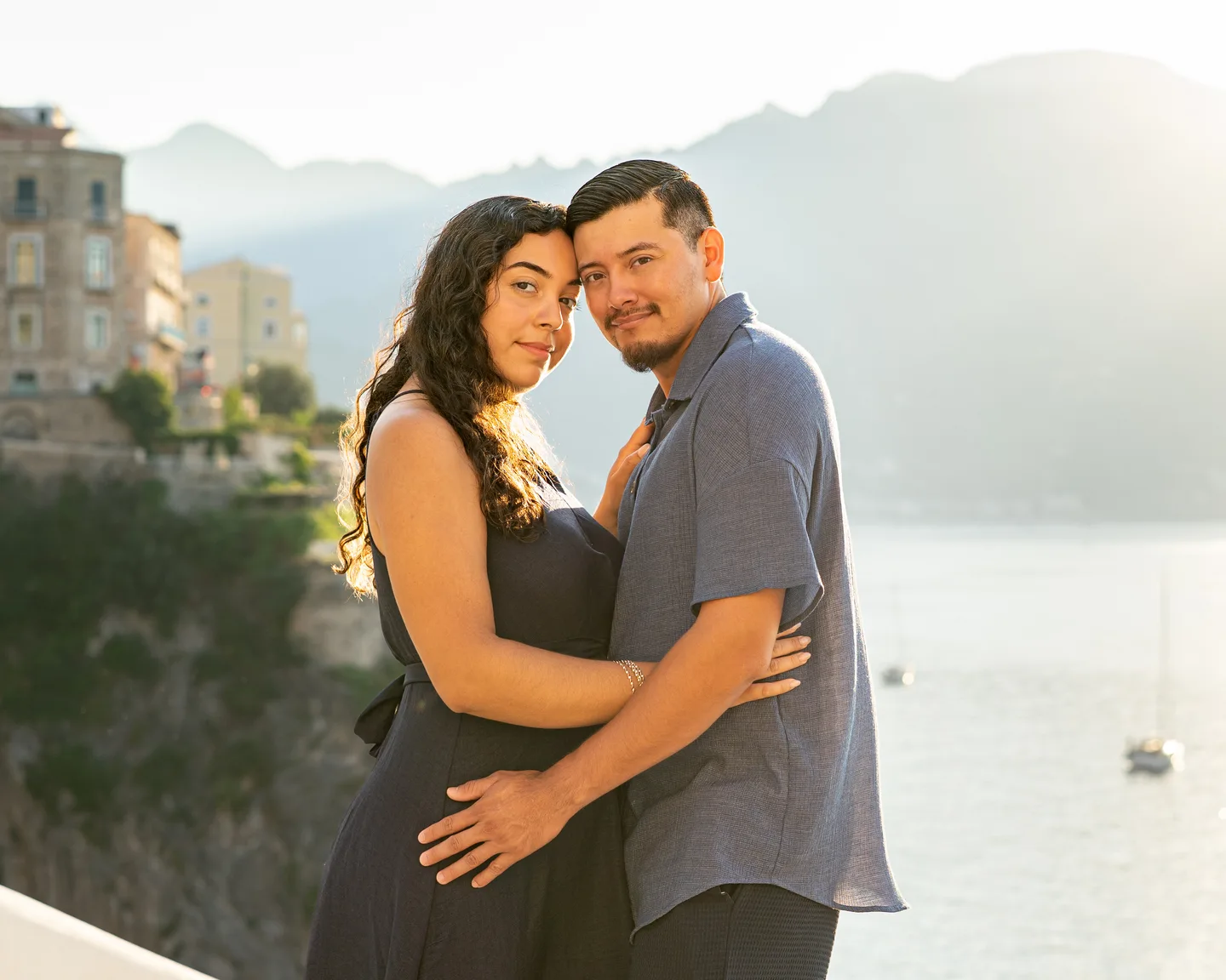A close embrace with the mountains and water behind the couple