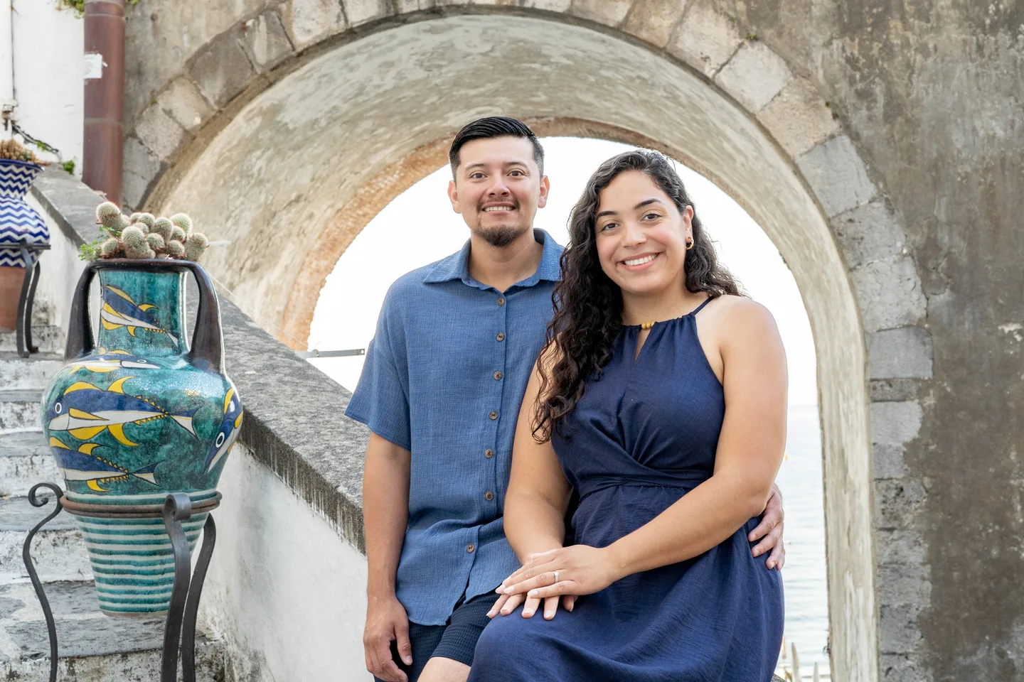 Esmeralda smiling with her companion beneath the village arch