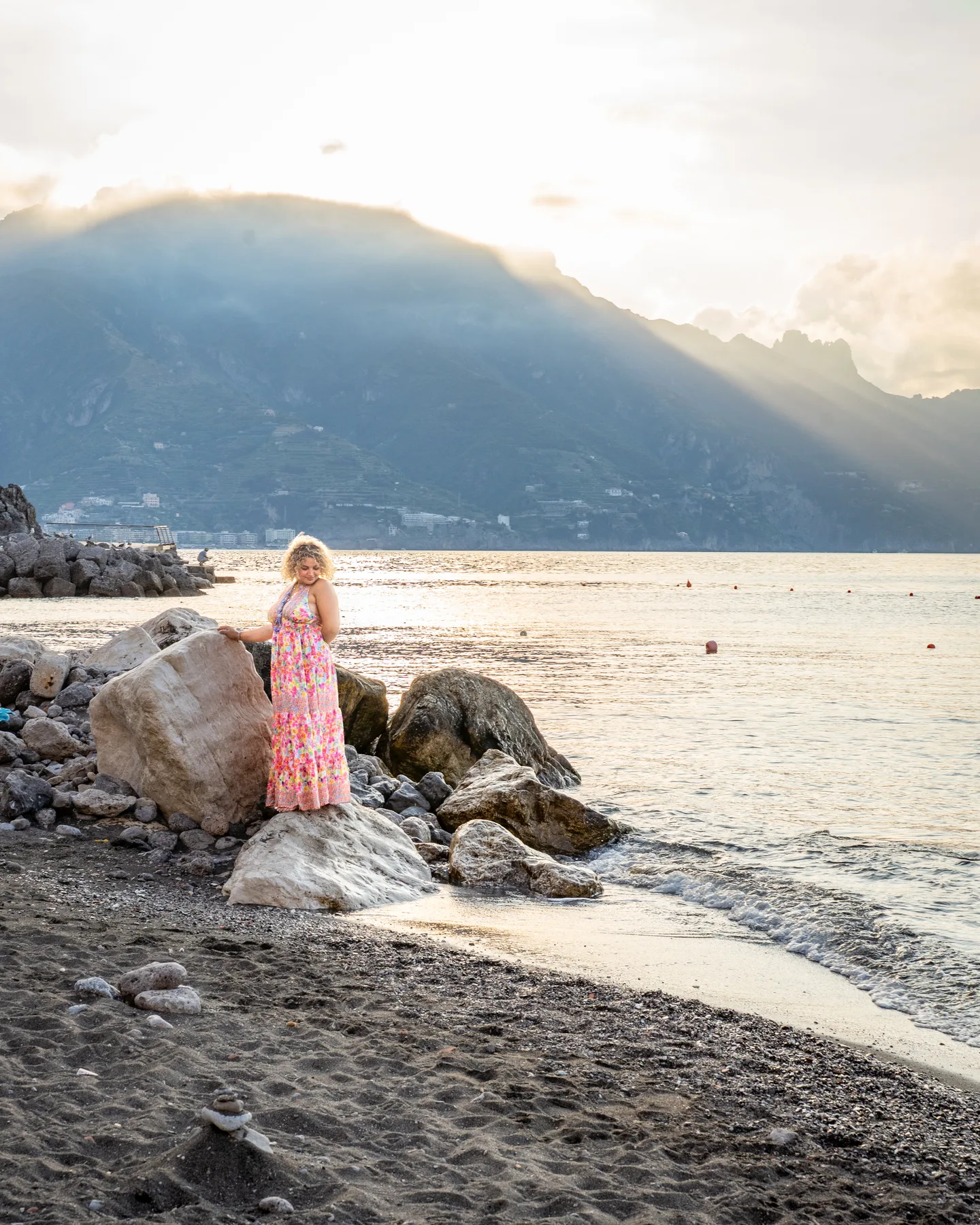 Hinad standing on the rocks above the water