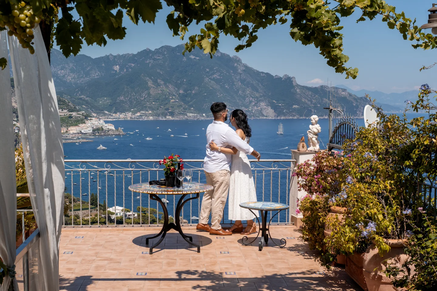The couple framed by the terrace and distant mountains