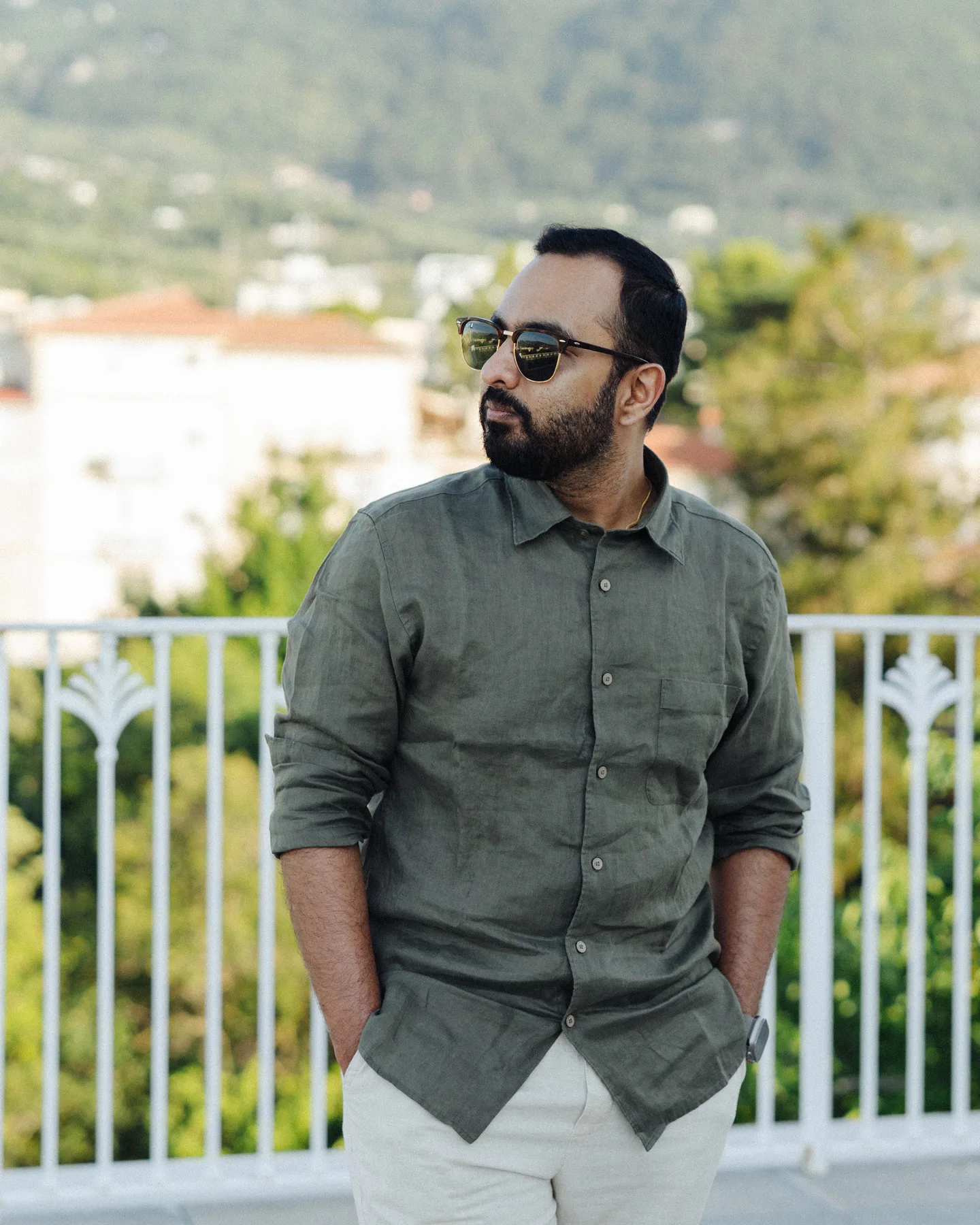 A portrait of Jatin beside the terrace railings