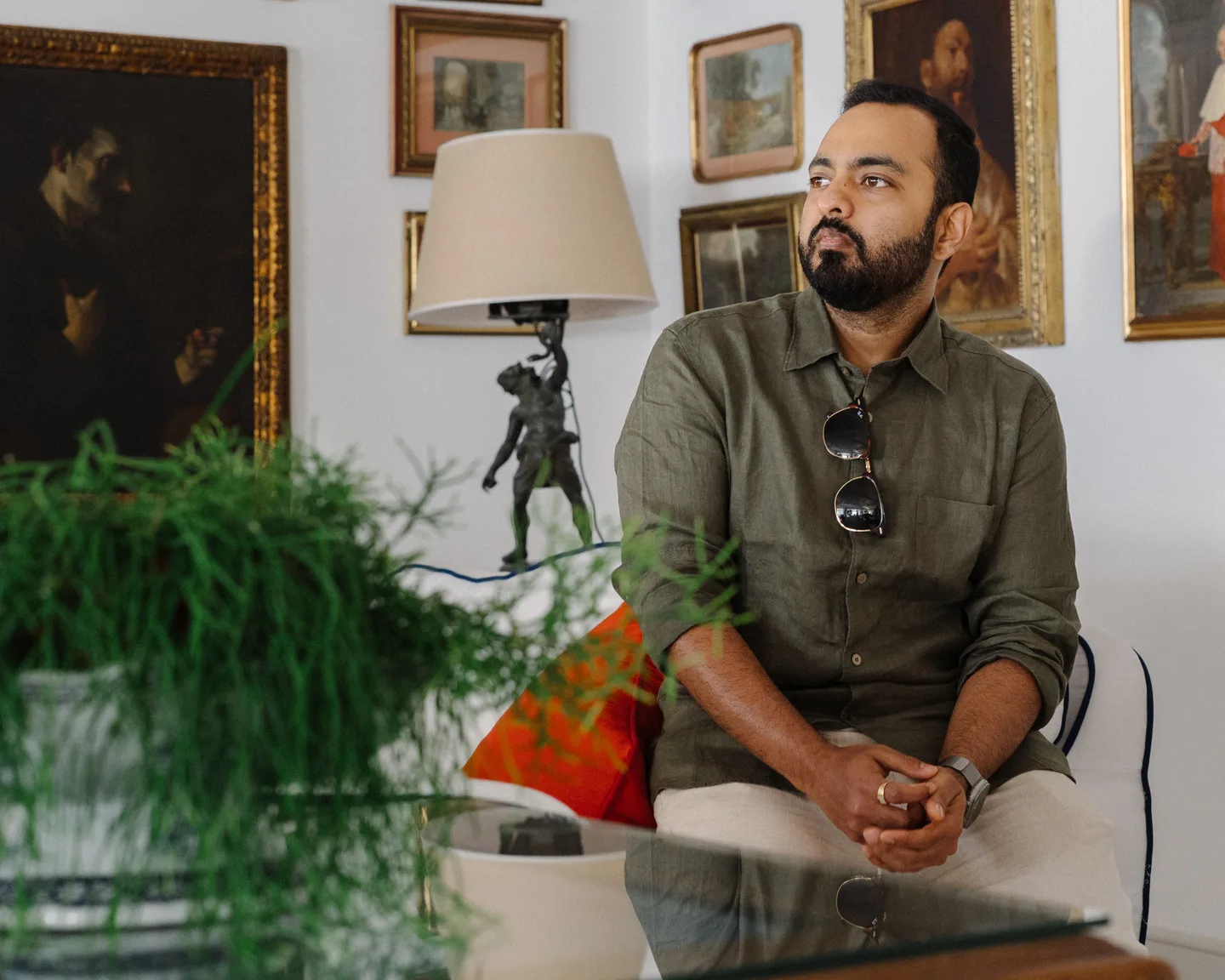 Jatin seated in the lounge among paintings