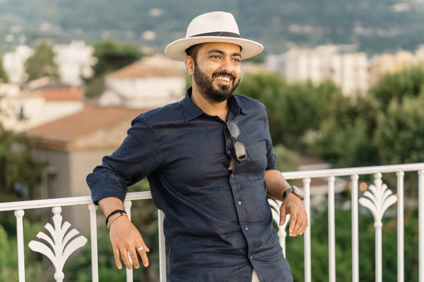 A portrait of Jatin in his hat and navy shirt