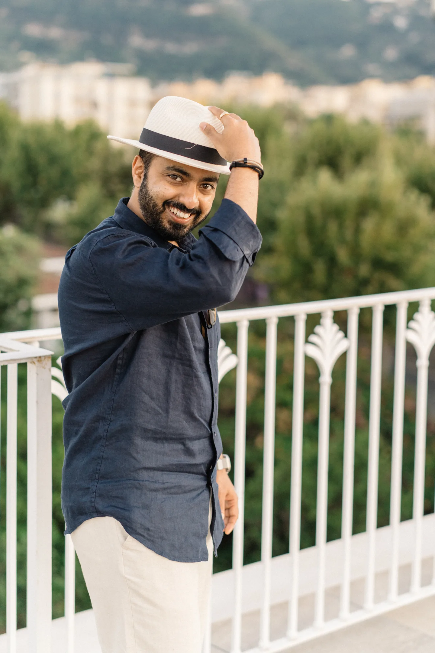Jatin laughing and holding his hat