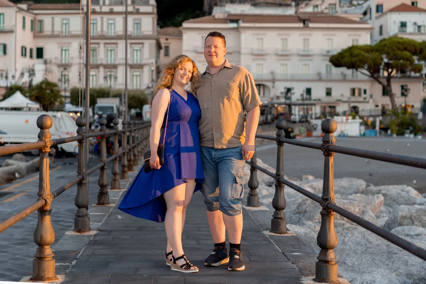 The couple walking along the waterfront