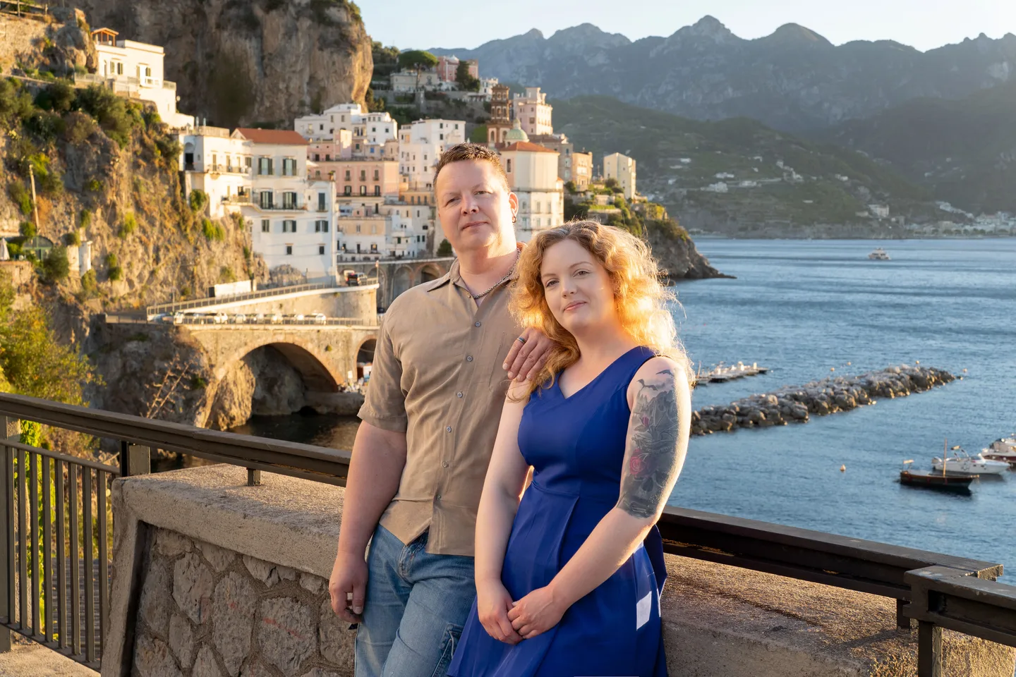 The couple with the coastline behind them