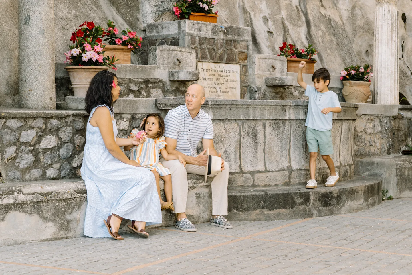 The family beside the stone fountain in Praiano