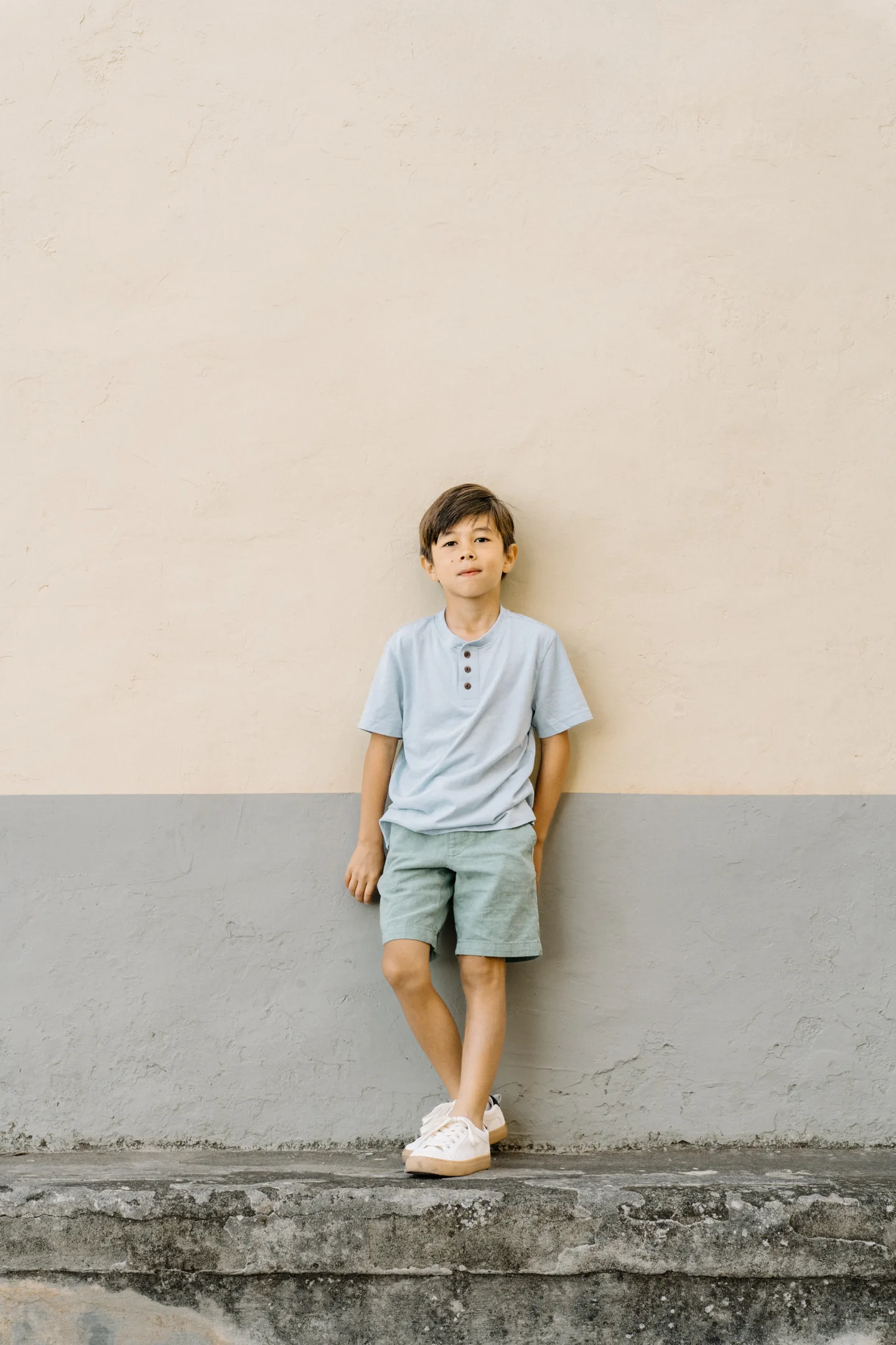 A portrait of Nick’s son against a pale wall