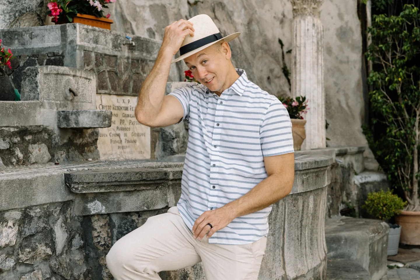 Nick tipping his hat beside the stone steps