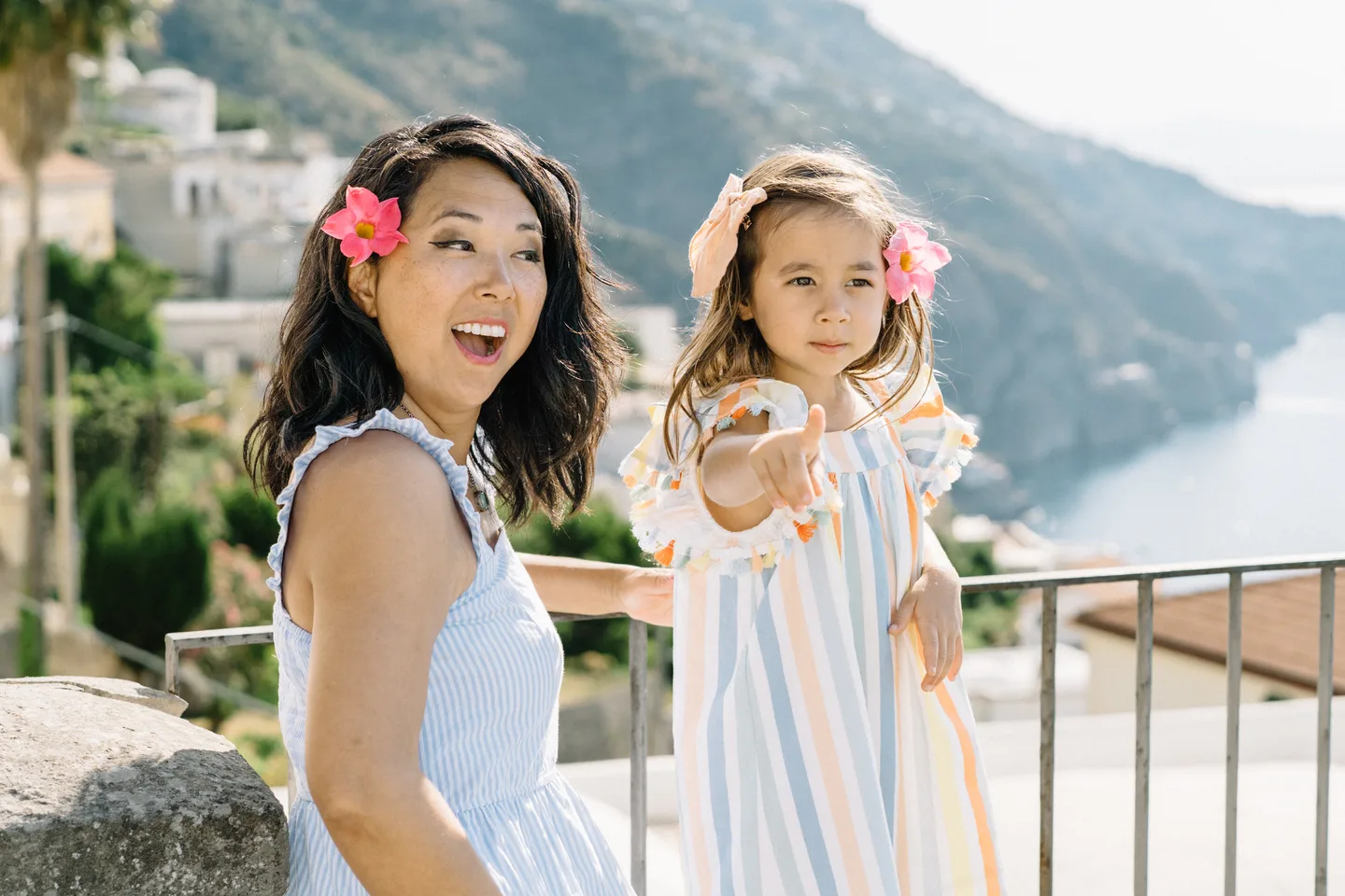 Mother and daughter smiling above the coast