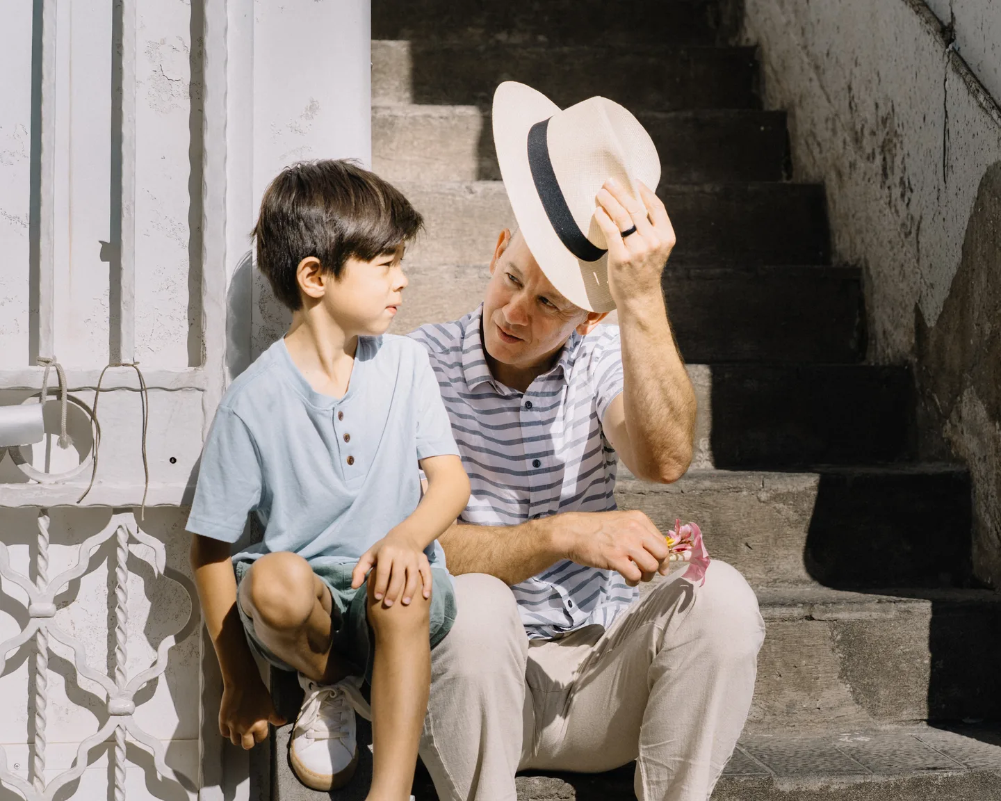 Nick and his son talking on the steps