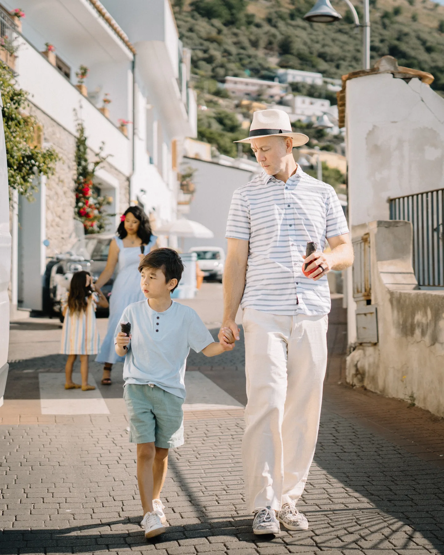 Nick and his son walking along a sunny lane