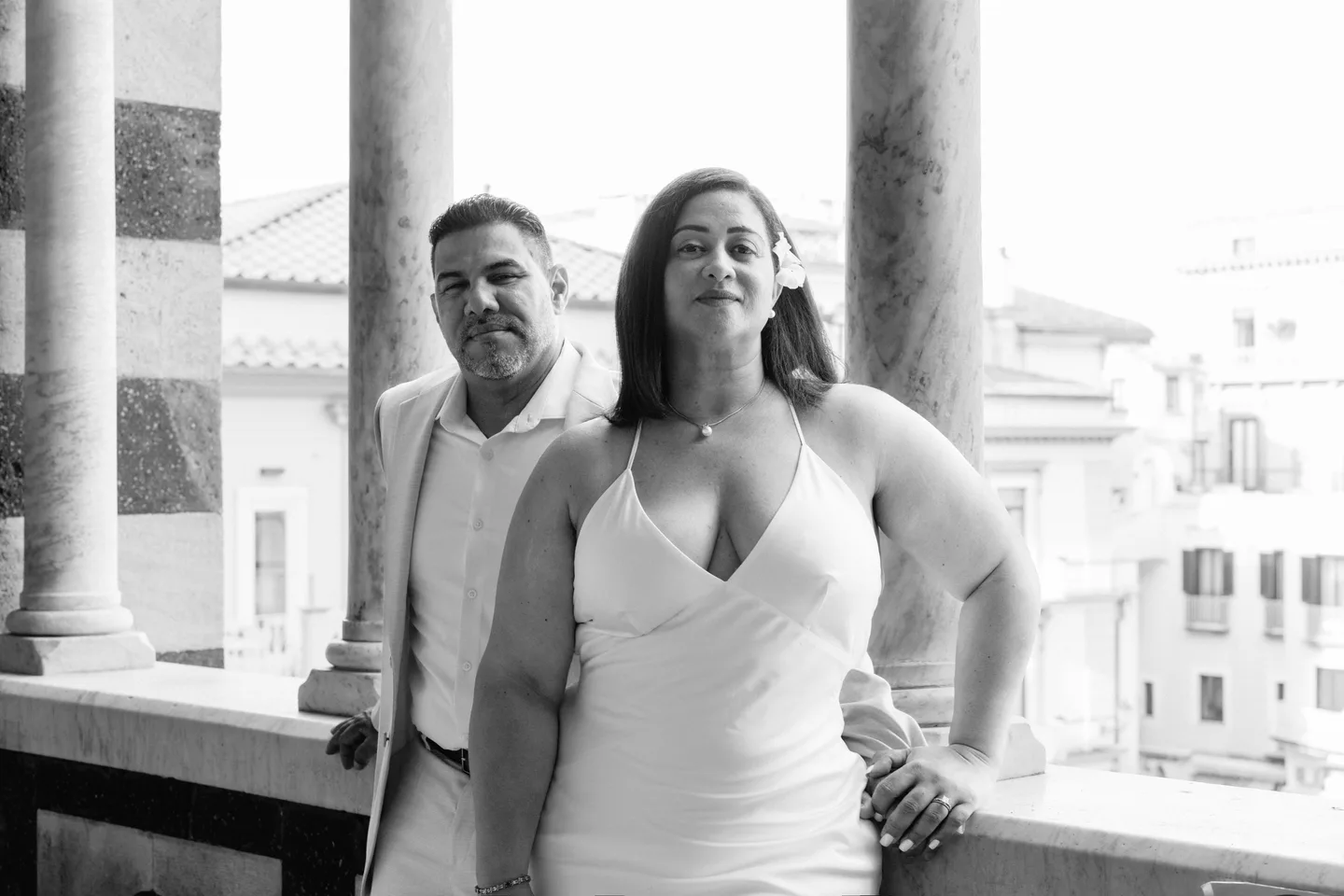 A black-and-white portrait of the couple beneath the cathedral portico