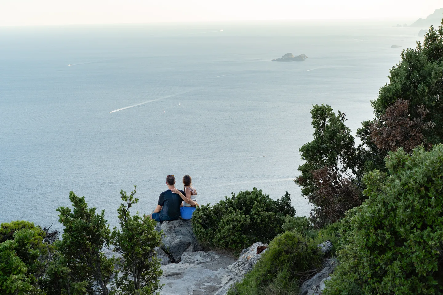 The couple sitting high above the sea