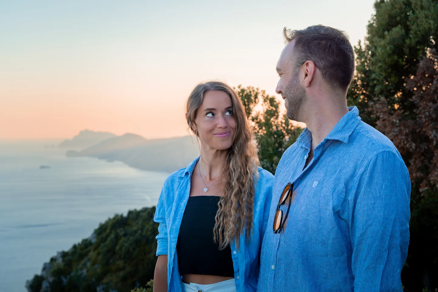 The couple looking at one another in evening light