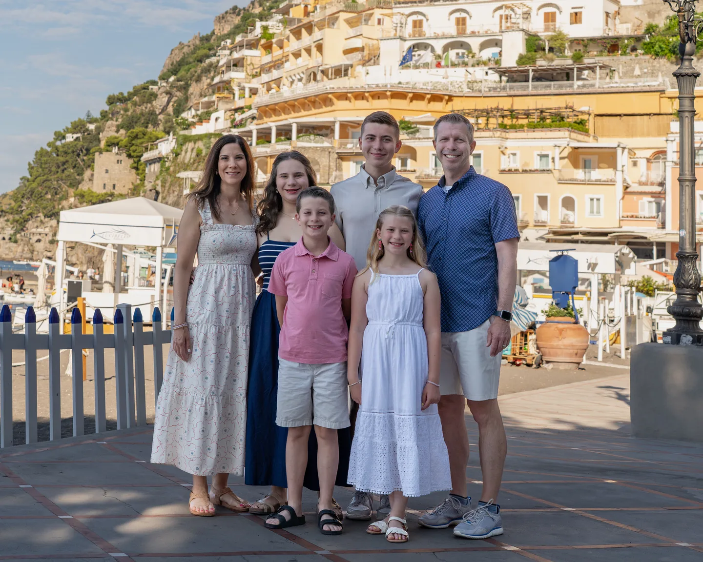 The whole family with Positano behind them