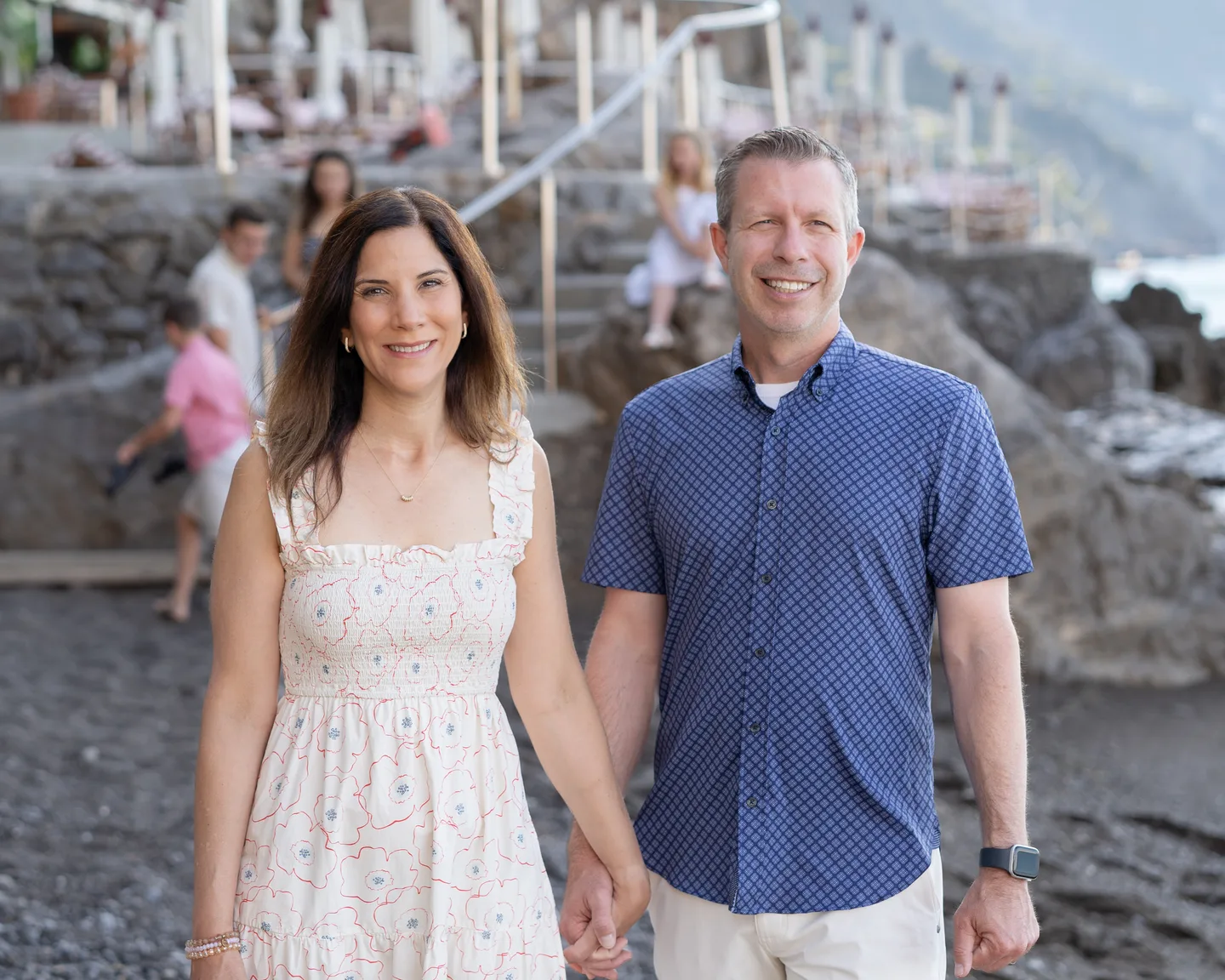 A couple portrait with the family in the background