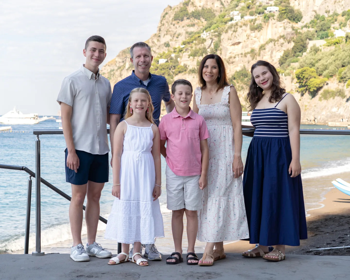 The whole family beside the waterfront railing