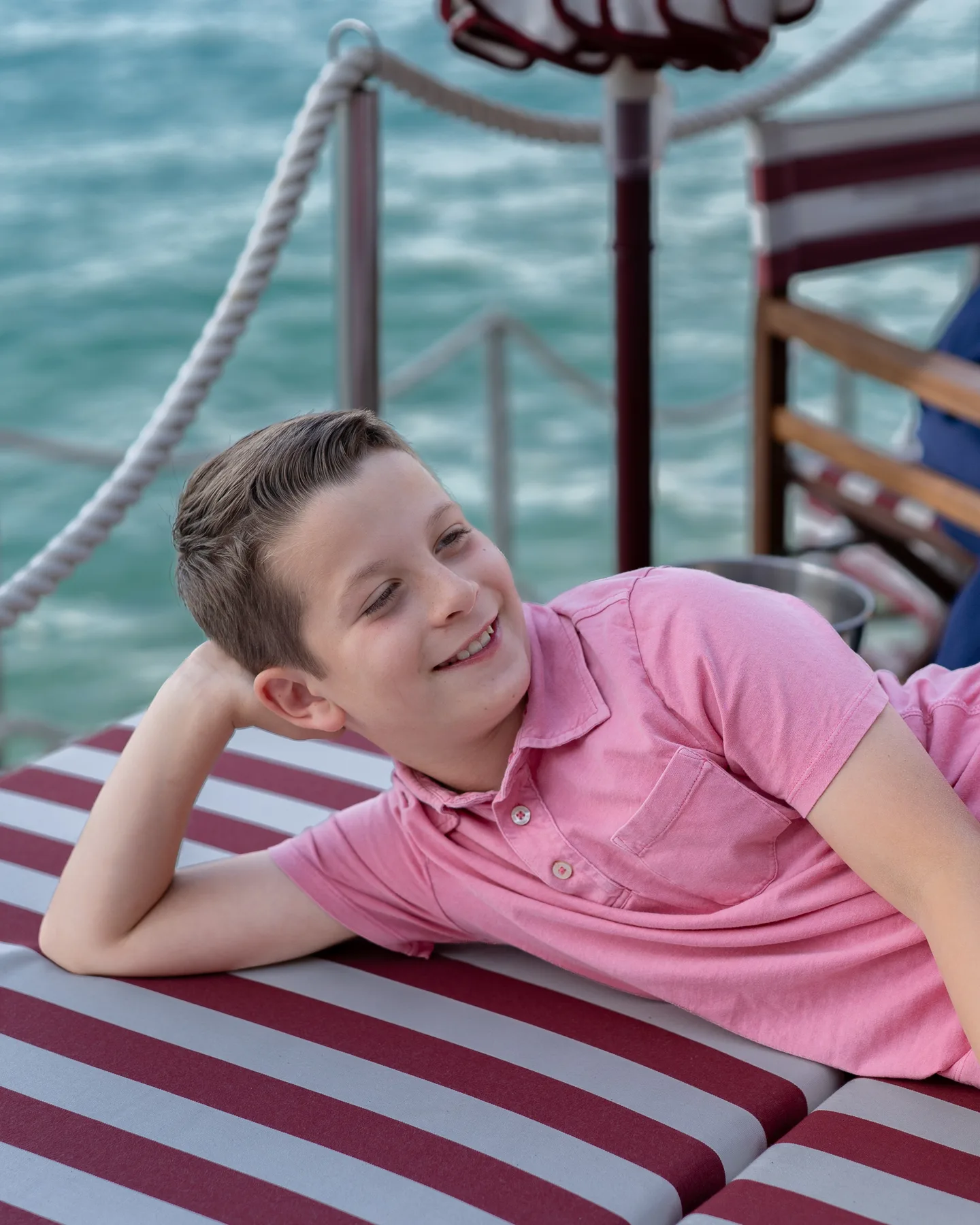 A portrait on a striped beach lounger
