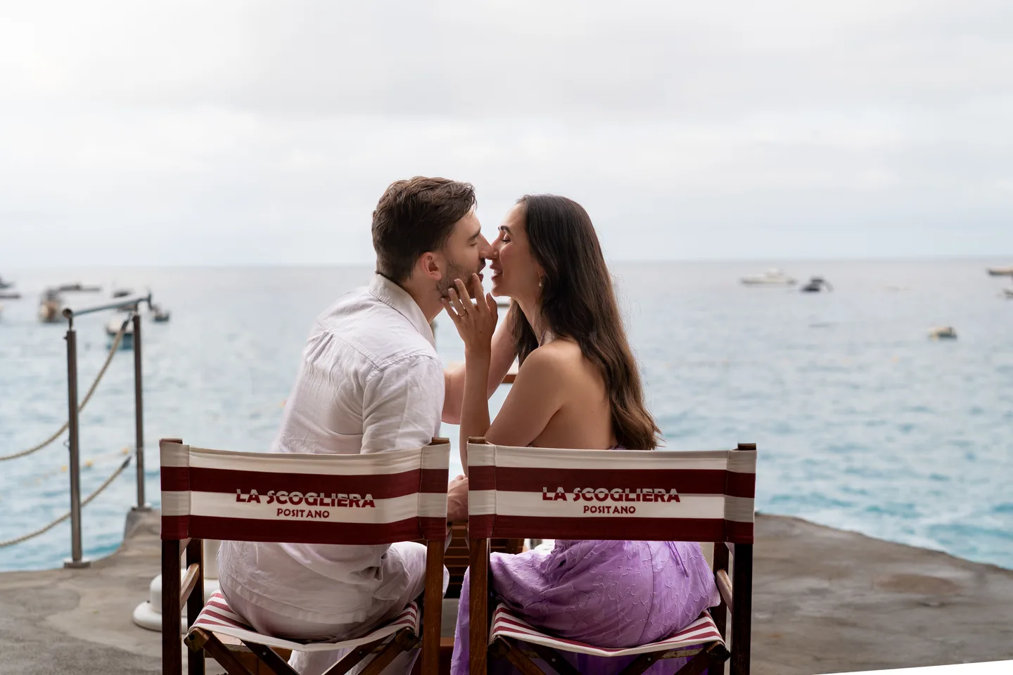 A kiss at a table overlooking the sea