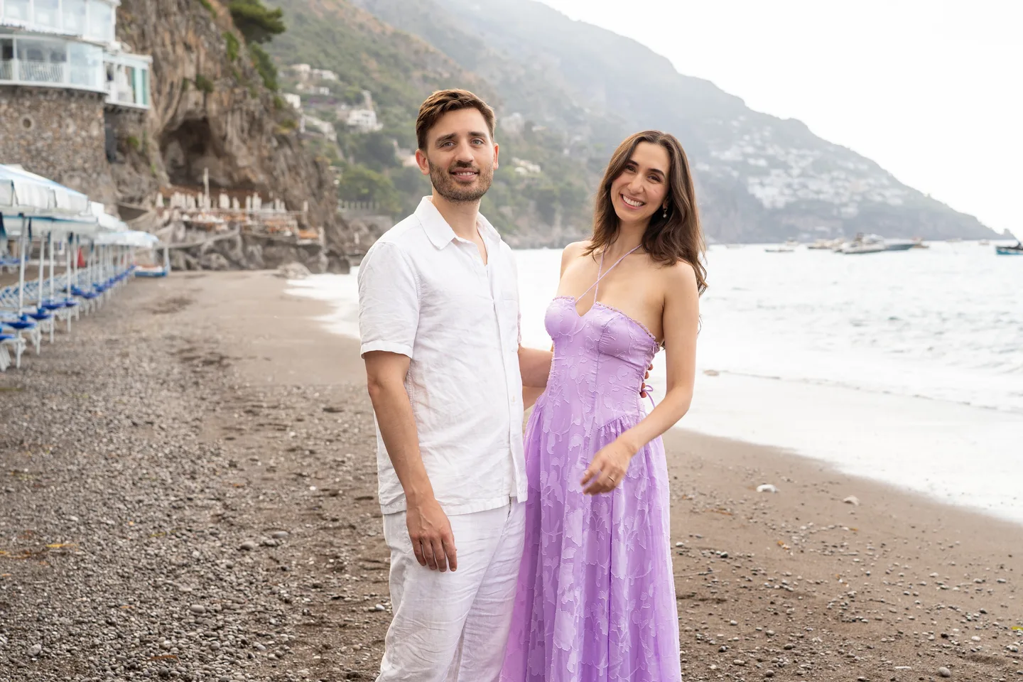 The couple holding hands on the beach
