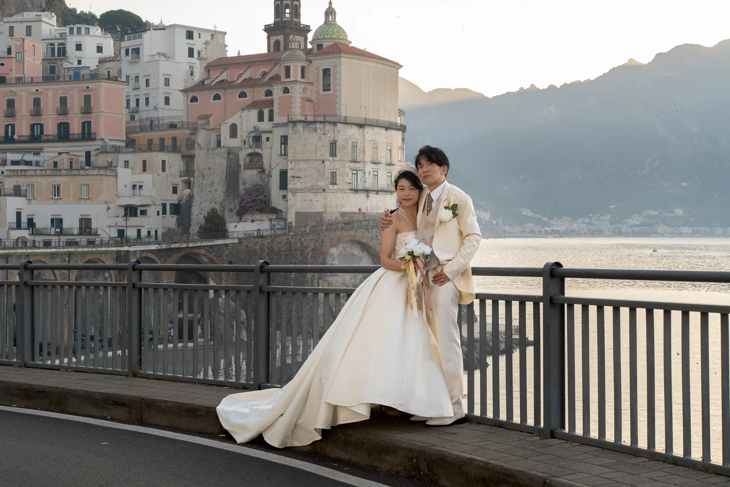 The couple standing close beside Atrani’s church