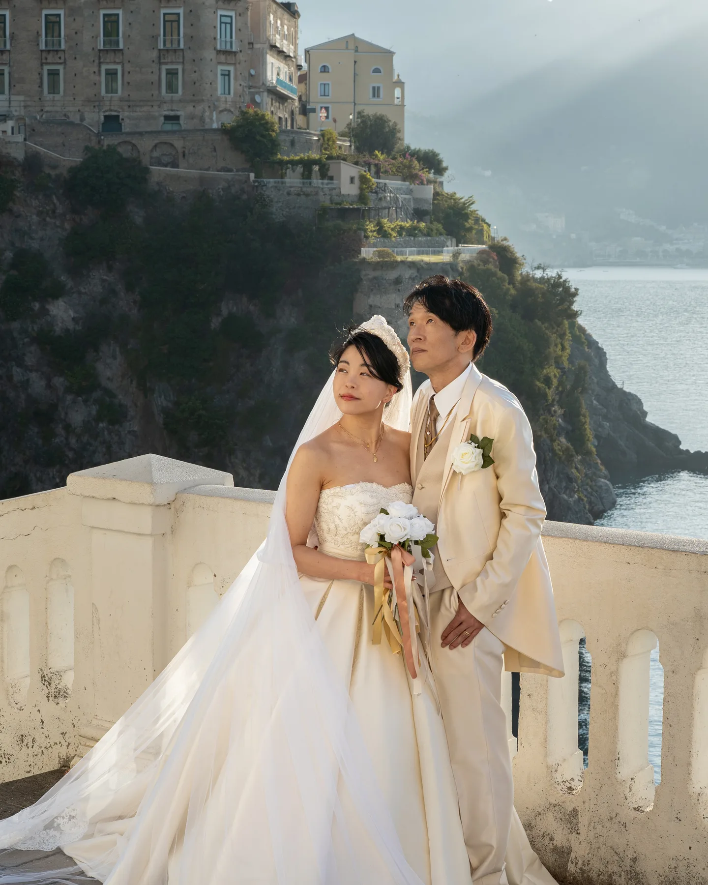 The couple together on the white terrace above the sea