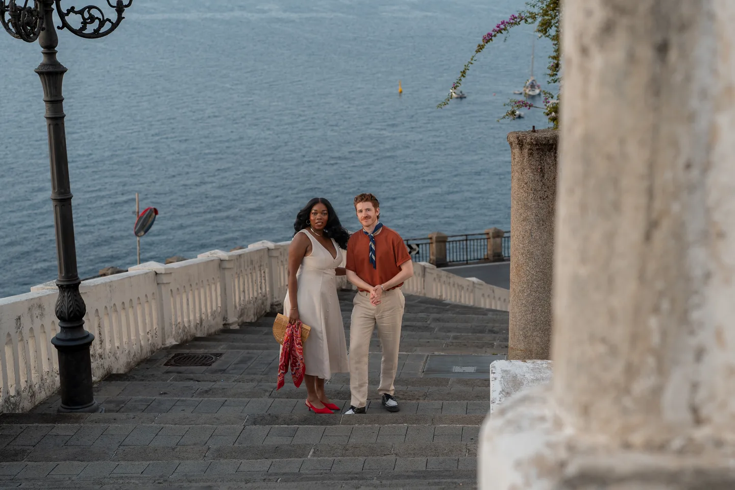 The couple climbing the seaside staircase
