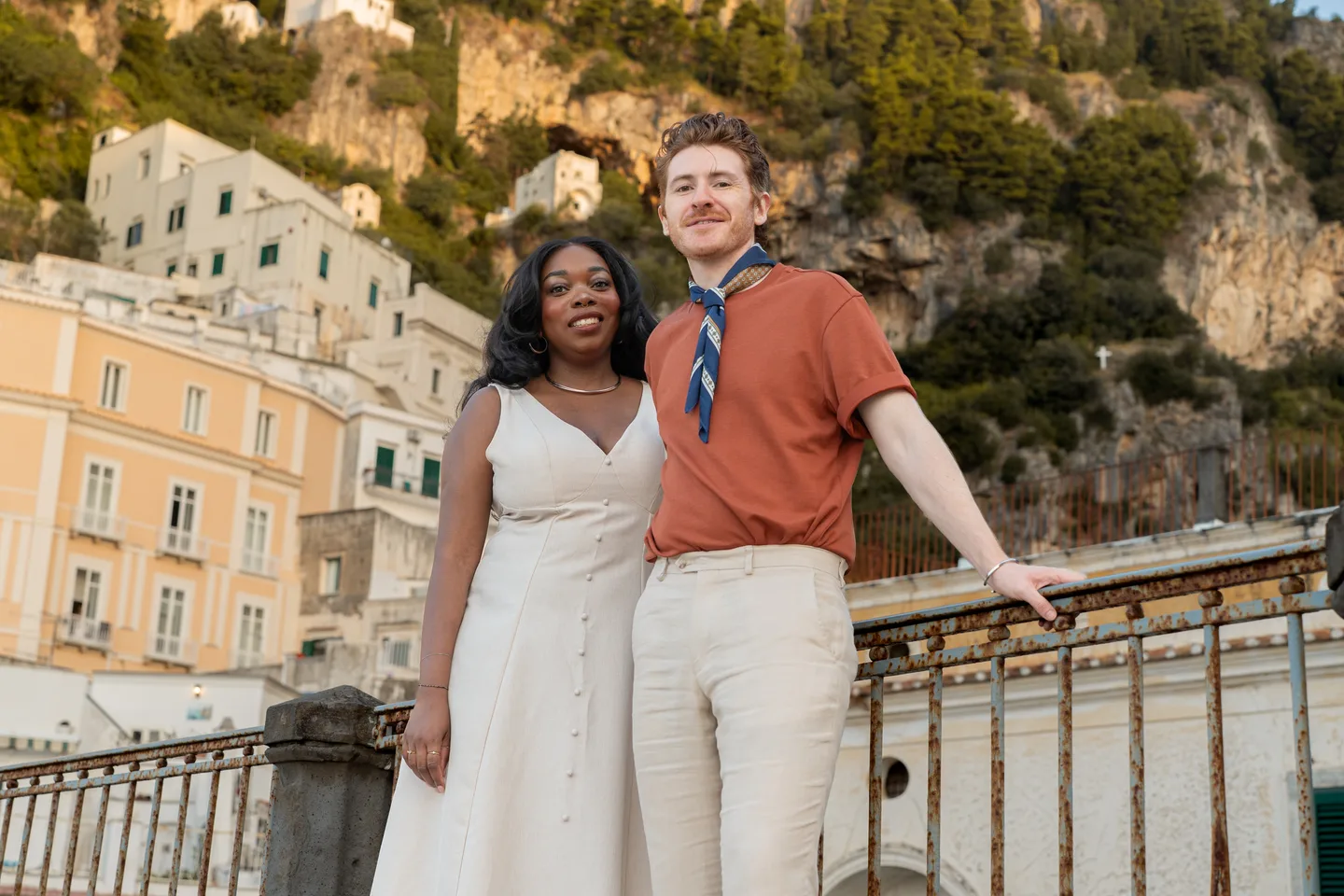 The couple leaning against the railing in the early light